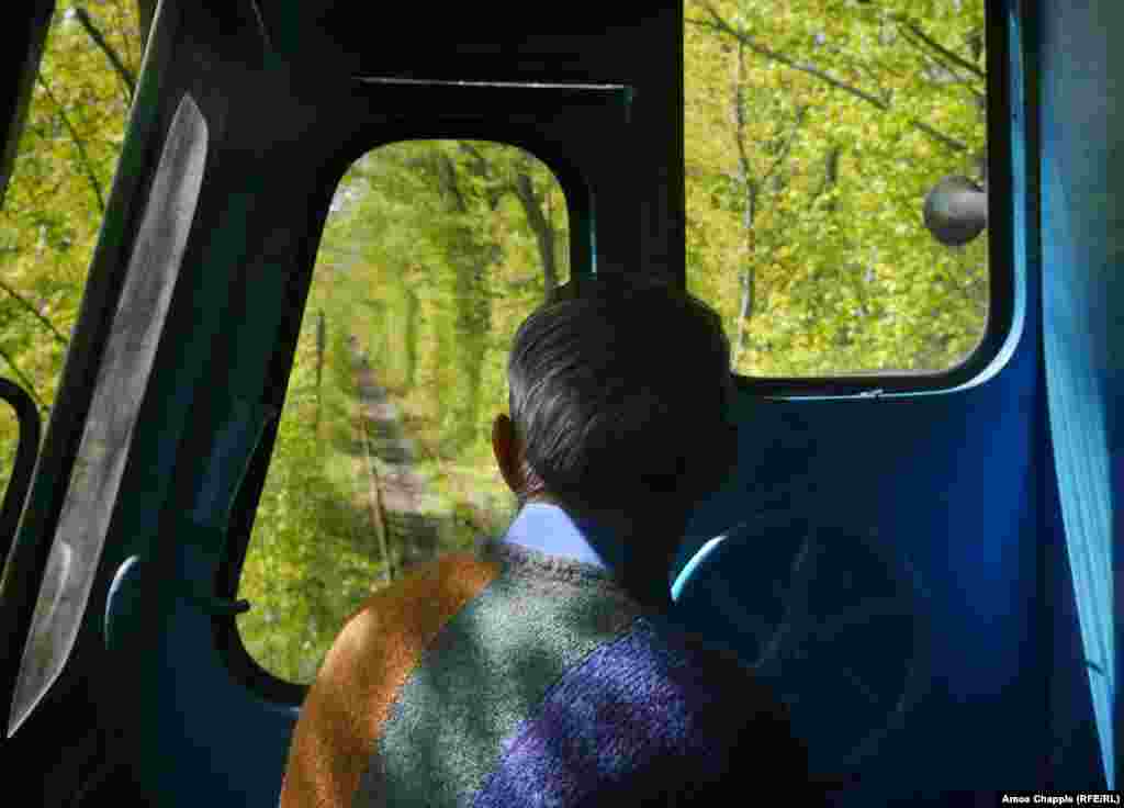 As the train nears Klevan, Havrylevych keeps a sharp eye on the track. Tourists, surprised by the train’s approach, crowd the track to take pictures. 
