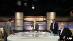 Incumbent Mahmud Ahmadinejad (left) and presidential challenger Mir Hossein Musavi (far right) in their televised debate on June 3.