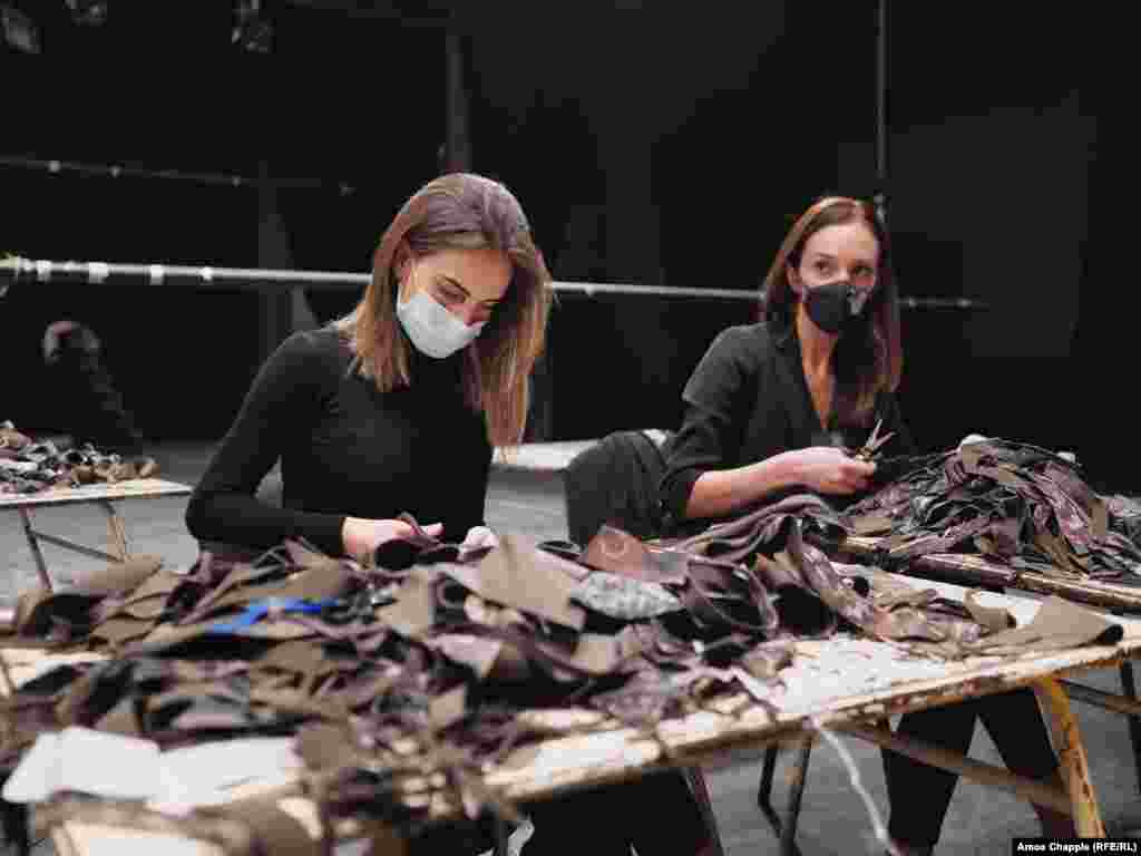 Scraps of waste fabric donated from various factories throughout Armenia are snipped into pieces…