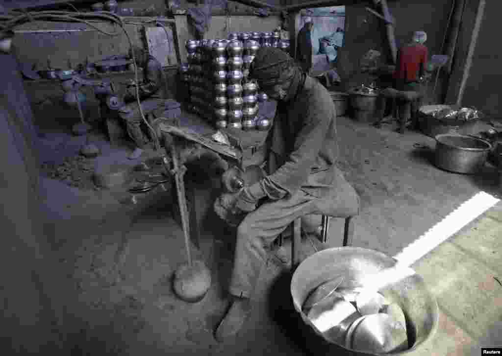 Afghan laborers polish metal pots at an aluminum factory in the western city of Herat. (Reuters/Mohmmad Shoib)