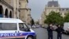 French police officials gather at the entrance to Notre-Dame cathedral in Paris on June 6, 2017