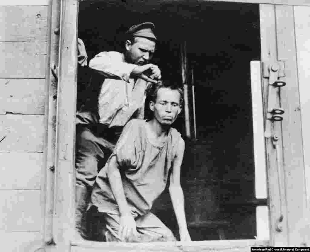 A Russian soldier having his hair cut. A Red Cross worker claimed the freed soldiers returned to Russia "violently bitter toward Germany, disgusted with the existing Russian government, and grateful toward Americans."