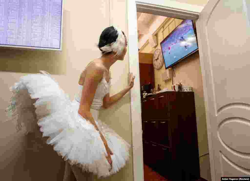 A ballerina watches a broadcast of the soccer World Cup quarterfinal match between Russia and Croatia at the Mikhailovsky Theater, St. Petersburg, Russia, on July 7. (Reuters/Anton Vaganov)