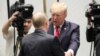 U.S. President Donald Trump (facing) greets Russian President Vladimir Putin in Danang, Vietnam, on November 11.