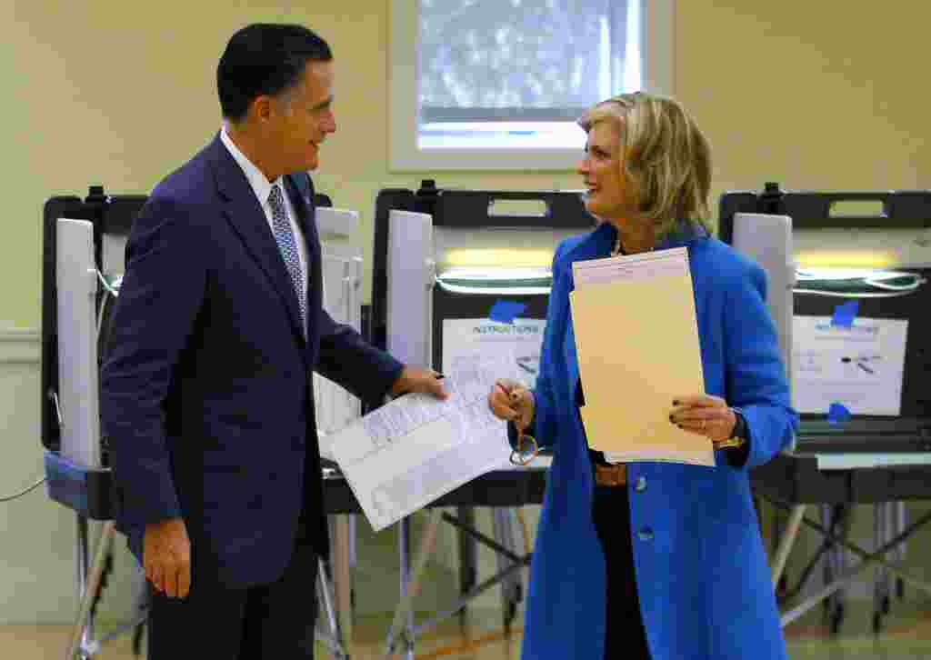 Republican presidential nominee Mitt Romney and his wife, Ann, finish filling out their ballots while voting in Belmont, Massachusetts.