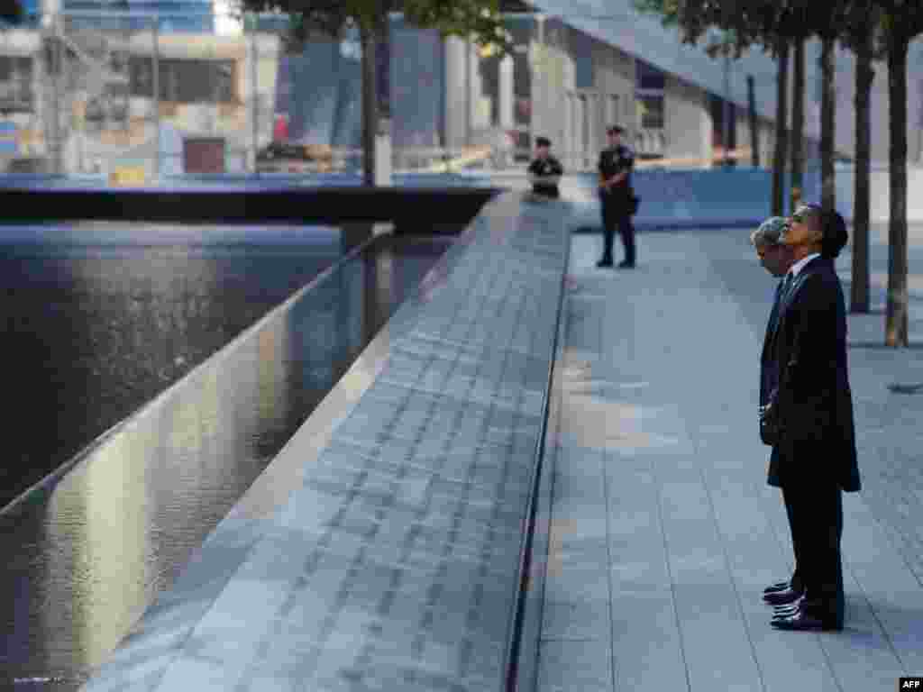 President Barack Obama, First Lady Michelle Obama, and ex-President George W. Bush visit the North Memorial Pond as they arrive for a commemoration ceremony.