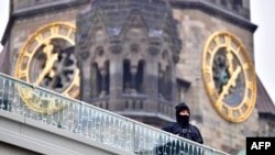 A policeman stands guard near the Kaiser-Wilhelm-Gedaechtniskirche (Kaiser Wilhelm Memorial Church) in Berlin, close to the site where a truck crashed into a Christmas market on December 19.