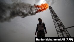 IRAQ -- An employee stands at the Hammar Mushrif new Degassing Station Facilities site inside the Zubair oil and gas field, north of the southern Iraqi province of Basra, May 9, 2018