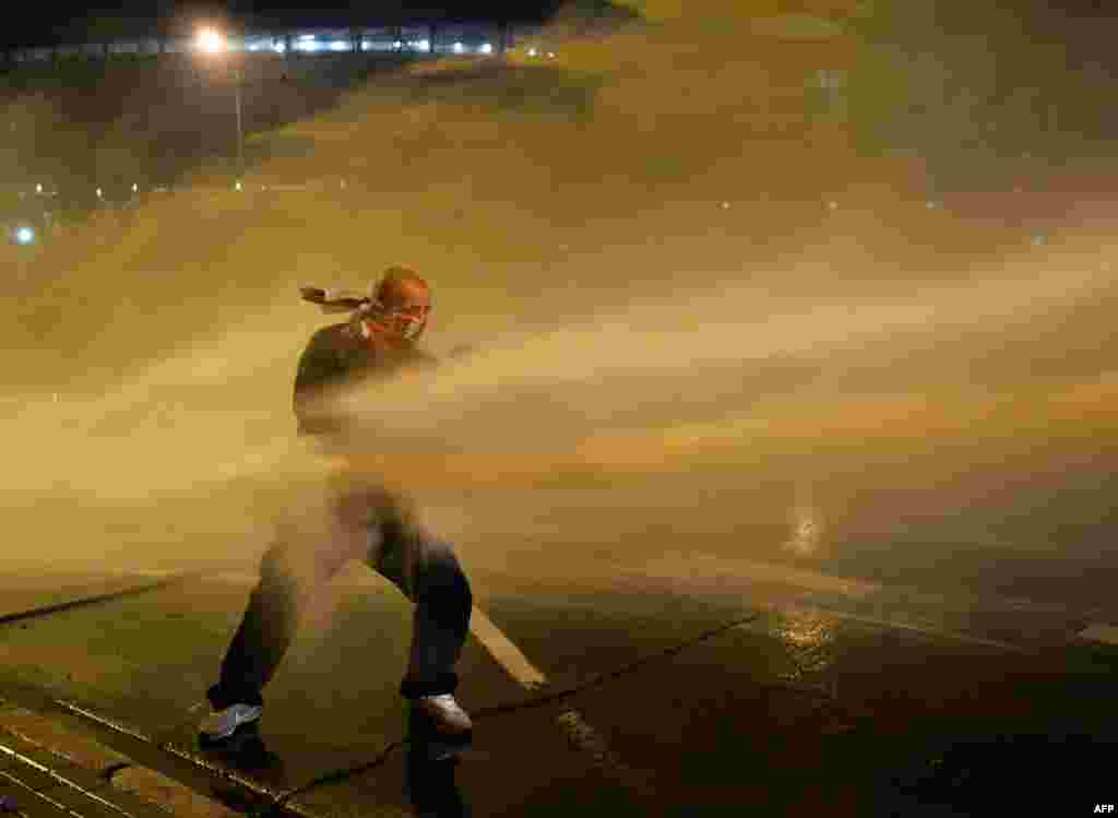 A right-wing nationalist protester is hit by a water cannon used by the police during a Polish Indepdence Day march in Warsaw on November 11. (AFP/Janek Skarzynski)