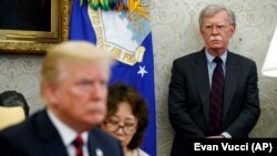 U.S. President Donald Trump, meets with South Korean President in the Oval Office of the White House, as national security adviser John Bolton (R) watches, in Washington, May 22, 2018