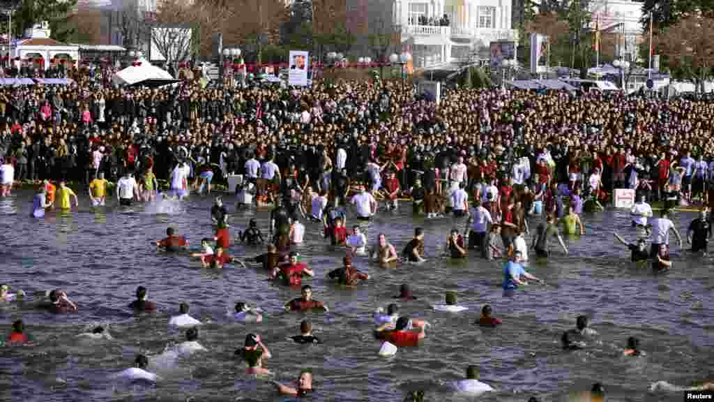 People swim in the ice-cold waters of Lake Ohrid, Macedonia, to search for a cross during Epiphany celebrations on January 19. (REUTERS/Ognen Teofilovski)