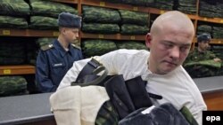 A Russian recruit carries his newly issued uniform during call-up. (file photo)