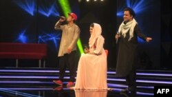 Afghan singer Zulala Hashemi (center) performs alongside competitors Sayed Jamal Mubarez (left) and Babak Mohammadi during the television music competition Afghan Star in Kabul in 2017.