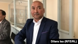 Erlan Baltabai appears in court in Shymkent on April 16.