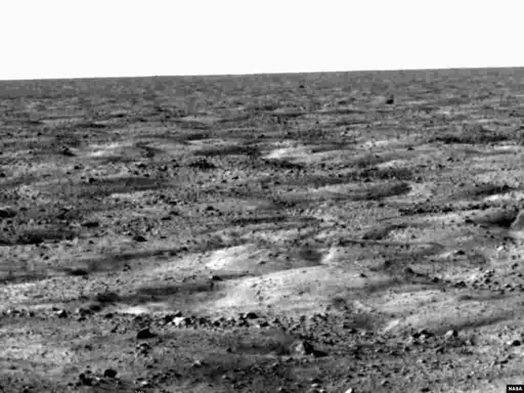 NASA's Phoenix Mars Mission - The flat landscape is strewn with tiny pebbles and shows polygonal cracking, a pattern seen widely in Martian high latitudes and also observed in permafrost terrains on Earth. The polygonal cracking is believed to have resulted from seasonal freezing and thawing of surface ice. Phoenix touched down on the Red Planet at 4:53 p.m. Pacific Time (7:53 Eastern Time), May 25, 2008, in an arctic region called Vastitas Borealis, at 68 degrees north latitude, 234 degrees east longitude. This image was taken shortly after landing by the spacecraft's Surface Stereo Imager. The Phoenix Mission is led by the University of Arizona, Tucson, on behalf of NASA. Project management of the mission is by NASA's Jet Propulsion Laboratory, Pasadena, Calif. Spacecraft development is by Lockheed Martin Space Systems, Denver. Image credit: NASA/JPL-Caltech/University of Arizona