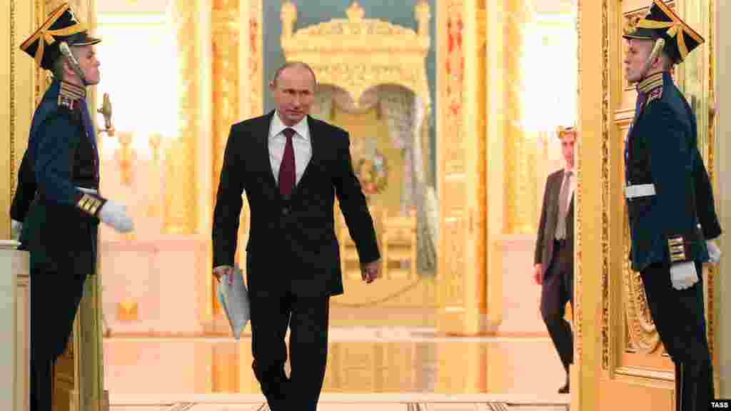 Russian President Vladimir Putin arrives to deliver the annual state-of-the-nation address at the Kremlin in Moscow. (ITAR-TASS/Mikhail Klimentyev)