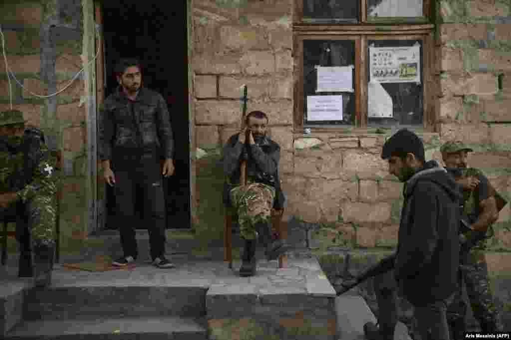 Ethnic Armenian gunmen rest in a village south of Stepanakert. &nbsp; In August 2020, just before the latest hostilities broke out, lawmaker Sasun Mikaelian called for a formal volunteer militia to be formed to supplement Armenia&rsquo;s military. Mikaelian said such a militia was necessary because Armenia was &ldquo;surrounded by enemies.&rdquo; &nbsp;