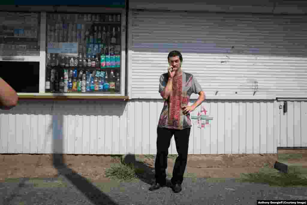 An Abkhazian man waits at a bus stop in central Sukhumi. 