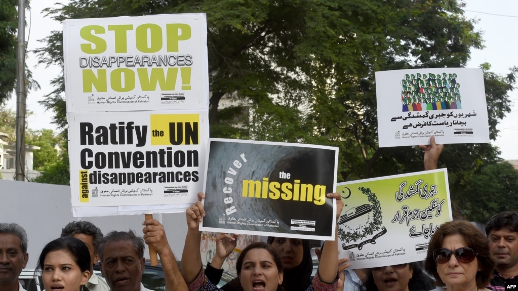 FILE: Pakistani human rights activists carry placards and banners during a protest for missing persons to mark the International Day of the Victims of Enforced Disappearances in Karachi.