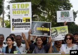 Pakistani human rights activists protest against enforced disappearances in Karachi.