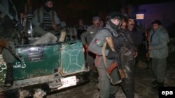 Afghanistan -- Afghan Police shift an injured victim from the scene of a suicide bombing that targeted a restaurant which is popular among foreigners, in Kabul, January 17, 2014