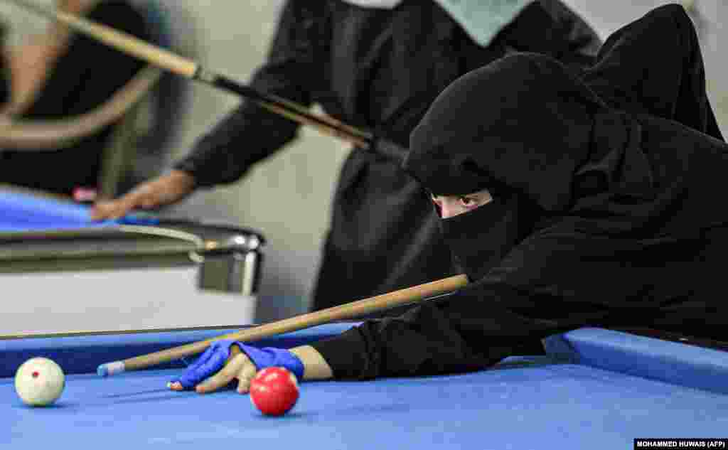 A woman plays billiards during a local championship at a sports hall in Yemen&#39;s capital, Sanaa. (AFP/Mohammed Huwais)