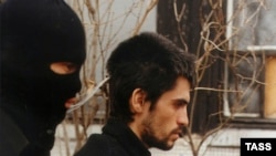 An alleged IMU member is handed over to Uzbek intelligence services by Russia (file photo).