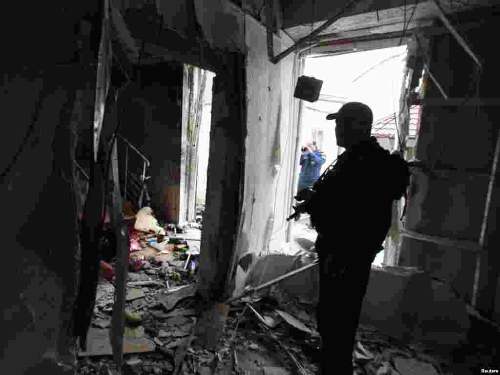 Chechnya -- A security officer stands guard inside the parliament building in Grozny, 19Oct2010 - A security officer stands guard inside the parliament building in Grozny October 19, 2010. Islamist rebels killed at least four people on Tuesday as they tried to seize Chechnya's parliament in a brazen suicide attack that showed Russia has failed to quell insurgency on its southern flank. REUTERS/Kazbek Basayev (RUSSIA - Tags: POLITICS CRIME LAW CIVIL UNREST 10poty