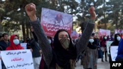 Afghan Solidarity members hold posters and chant slogans as they stage a protest against the stoning of Rukhshana in the capital Kabul in November.