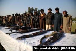 Former militants surrender their weapons during a reconciliation ceremony in Jalalabad in December 2019.