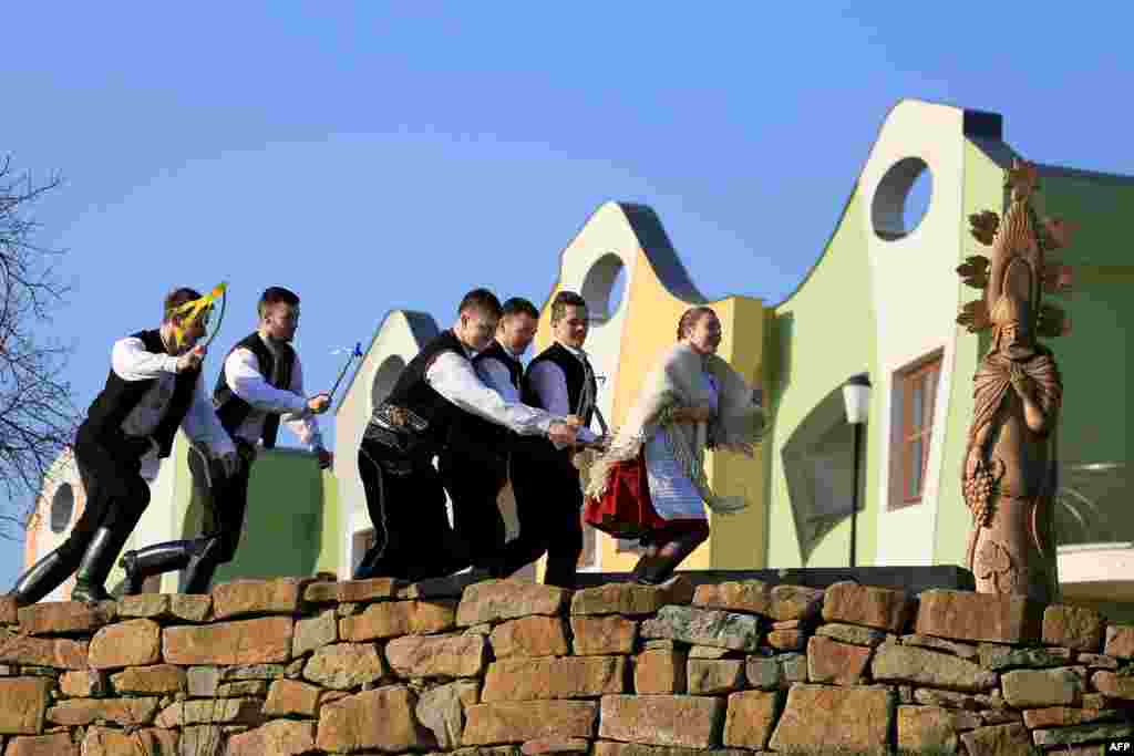 Boys in traditional costumes symbolically beat a girl with small whips during Easter Monday festivities in the Czech town of Velke Pavlovice. (AFP/Radek Mica)&nbsp;