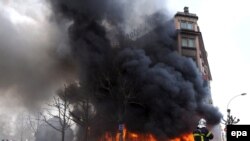 Firefighters battle flames at the Strasbourg hotel set alight during the NATO summit on April 4.