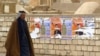 Election posters on a wall at Al-Najaf cemetery in Iraq