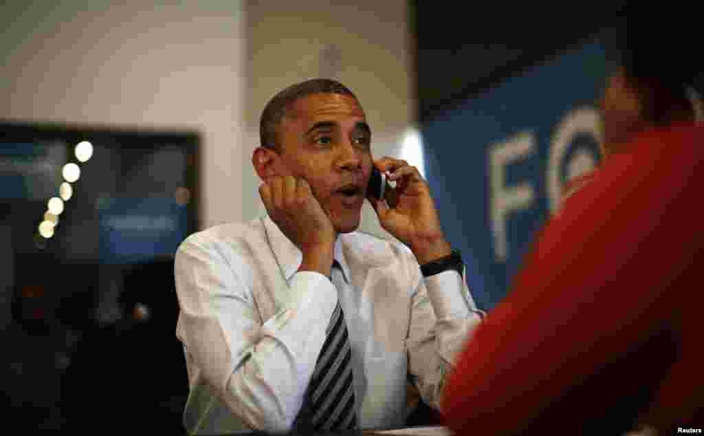 U.S. President Barack Obama makes a phone call to a campaign volunteer during a visit to a field office in Chicago on Election Day.