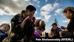 Russia -- file -- August 15, 2016 -- Yadne family members gather around slaughtered rendeer to enjoy fresh meet and blood in the family herding camp on the left bank of Yenisey river in West Siberia