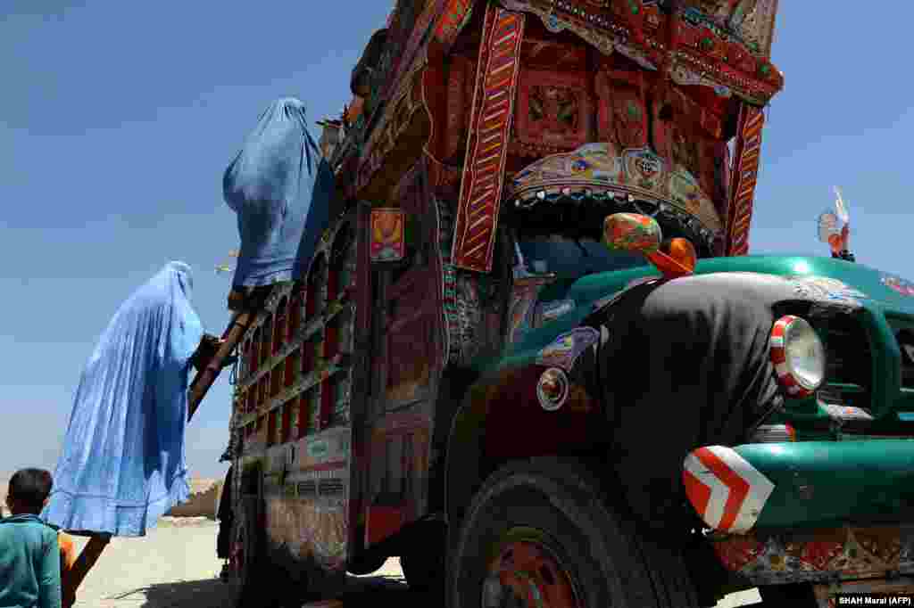 An Afghan refugee family climbs onto a truck at a United Nations High Commissioner for Refugees (UNHCR) camp in Kabul. (AFP/Shah Marai)