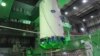 A cask of nuclear fuel is lifted and moved by workers during operations to remove fuel rods from a spent fuel pool inside the No.4 reactor building at Tokyo Electric Power Co's (TEPCO) Fukushima Daiichi nuclear power plant on November 18.