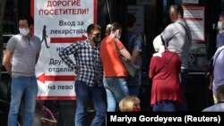 People stand in line outside a pharmacy in Almaty, Kazakhstan. In Almaty, customers at one pharmacy arrived to find long handwritten lists of all the medicines that were not available.