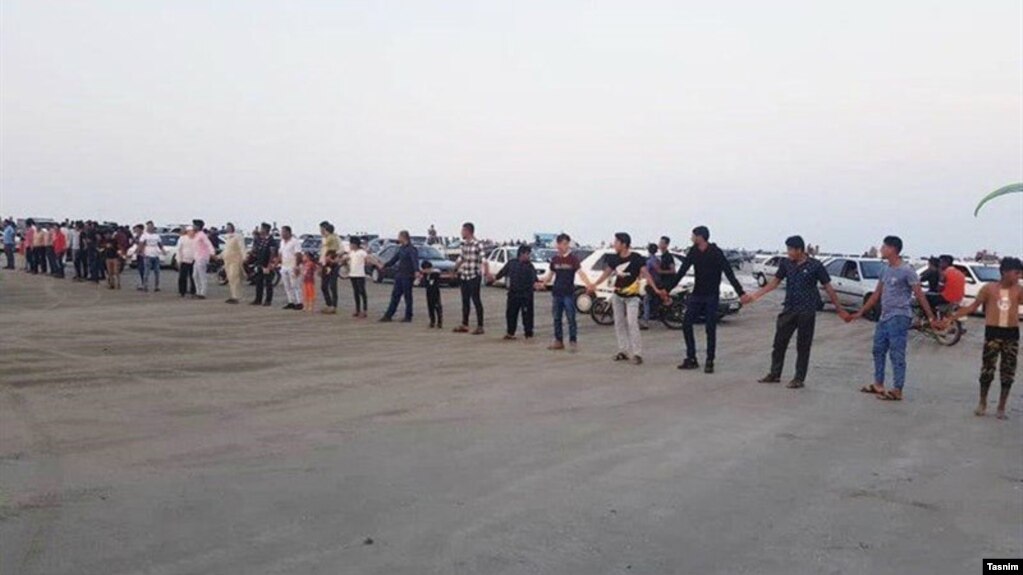 Residents for a human chain in Iran's Qeshm island to protest decision handing over tourism services to private sector. October 21, 2019