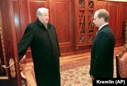 The late Russian President Boris Yeltsin (left) smiles as he talks to Vladimir Putin on December 31, 1999, the day he named his prime minister acting president.