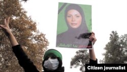 An opposition supporter holds a picture of Neda Agha Soltan at an anti-government demonstration in 2009.