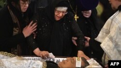 The mother of Andrei Karlov, the slain Russian ambassador to Turkey, cries next to his open coffin during a funeral ceremony at the Christ the Savior Cathedral in Moscow on December 22.