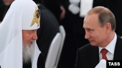 Президент России Владимир Путин (справа) и патриарх Русской православной церкви Кирилл. Москва, 28 июля 2015 года.