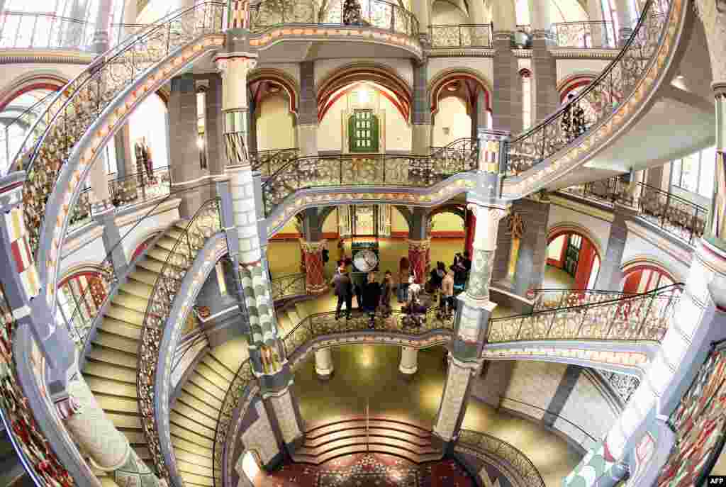 Visitors stand in the staircase of the restored former Prussian justice palace that serves now as the county court in Halle an der Saale in eastern Germany. The 110-year-old building houses 20 courtrooms, 110 offices, and a further 100 rooms and reopened after two years of restoration. (AFP/Jan Woitas)