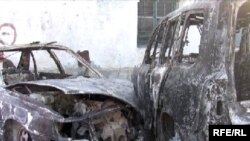 Burned-out vehicles at the site of the disputed accident where the bodies of Medet Sadyrkulov and two other men were found.