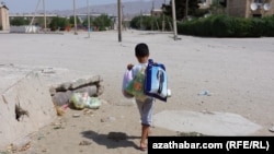 A boy carries groceries in Balkanabat. Amid Turkmenistan's economic crisis and deepening poverty, there has been an increase in anecdotal reports of burglary, mugging, and supermarket theft across the country.