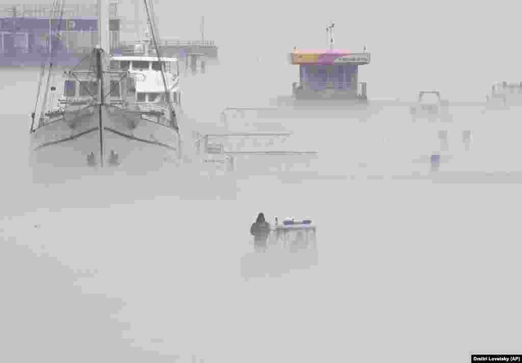 A patrol boat is seen through fog along the Neva River in St. Petersburg, Russia. (AP/Dmitri Lovetsky)