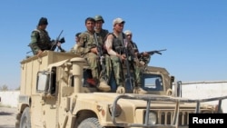 Afghan security forces arrive to fight with Taliban forces in Helmand on October 21.