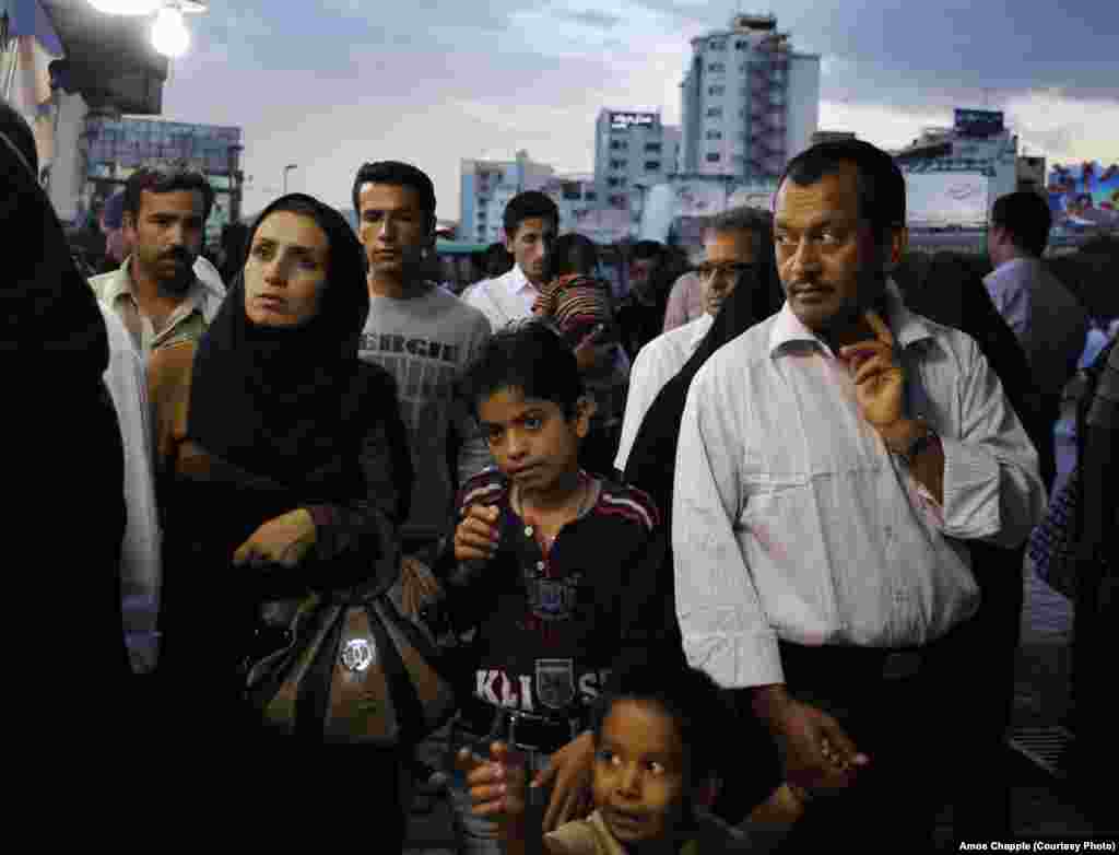 People on the street in Mashhad, a city in the east of Iran, near the Afghan border. Eastern Iran is generally more conservative and Islamic than the West. 