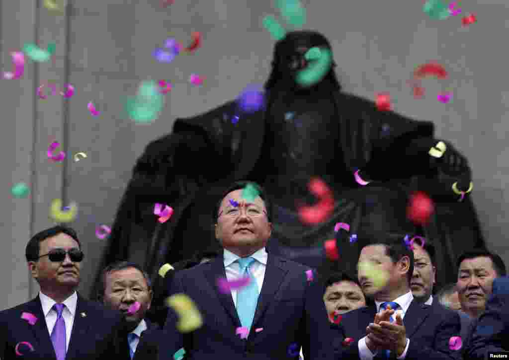 Mongolian President Tsakhia Elbegdorj (center) celebrates his reelection with members of his cabinet on Sukhbaatar Square in downtown Ulan Bator. (Reuters/Carlos Barria)